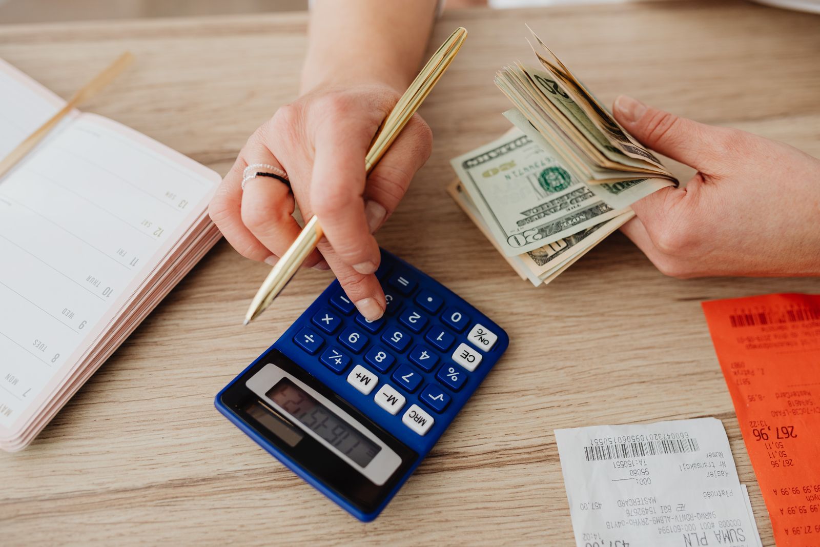 Comparing mortgage statements and a calculator at a kitchen table