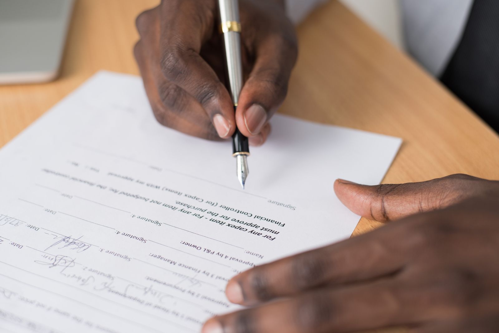 Mortgage documents and a pen laid out on a desk